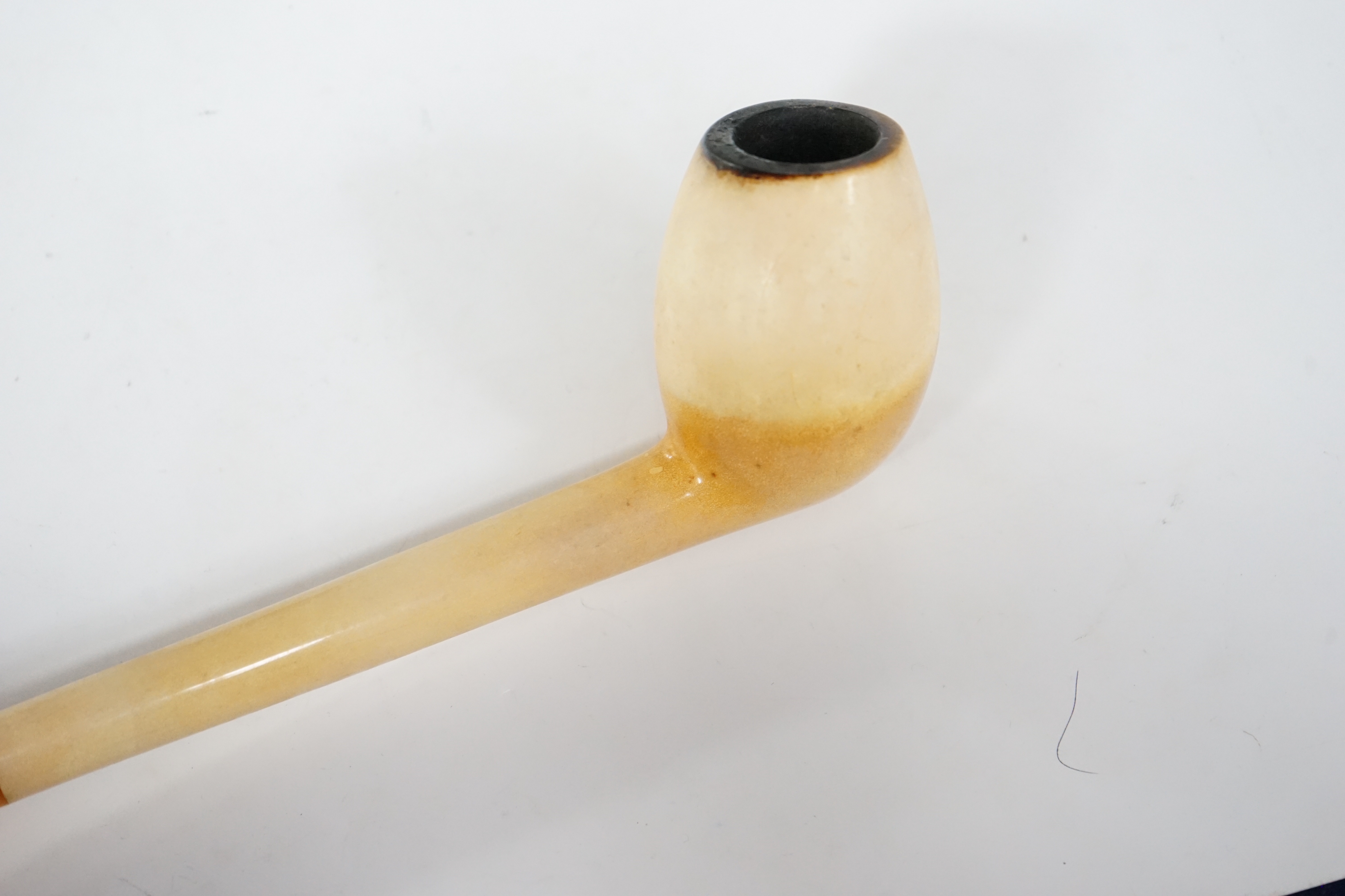 A cased and stamped Vienna Exhibition 1873 composite bowled pipe and amber mouthpiece, 26cm long